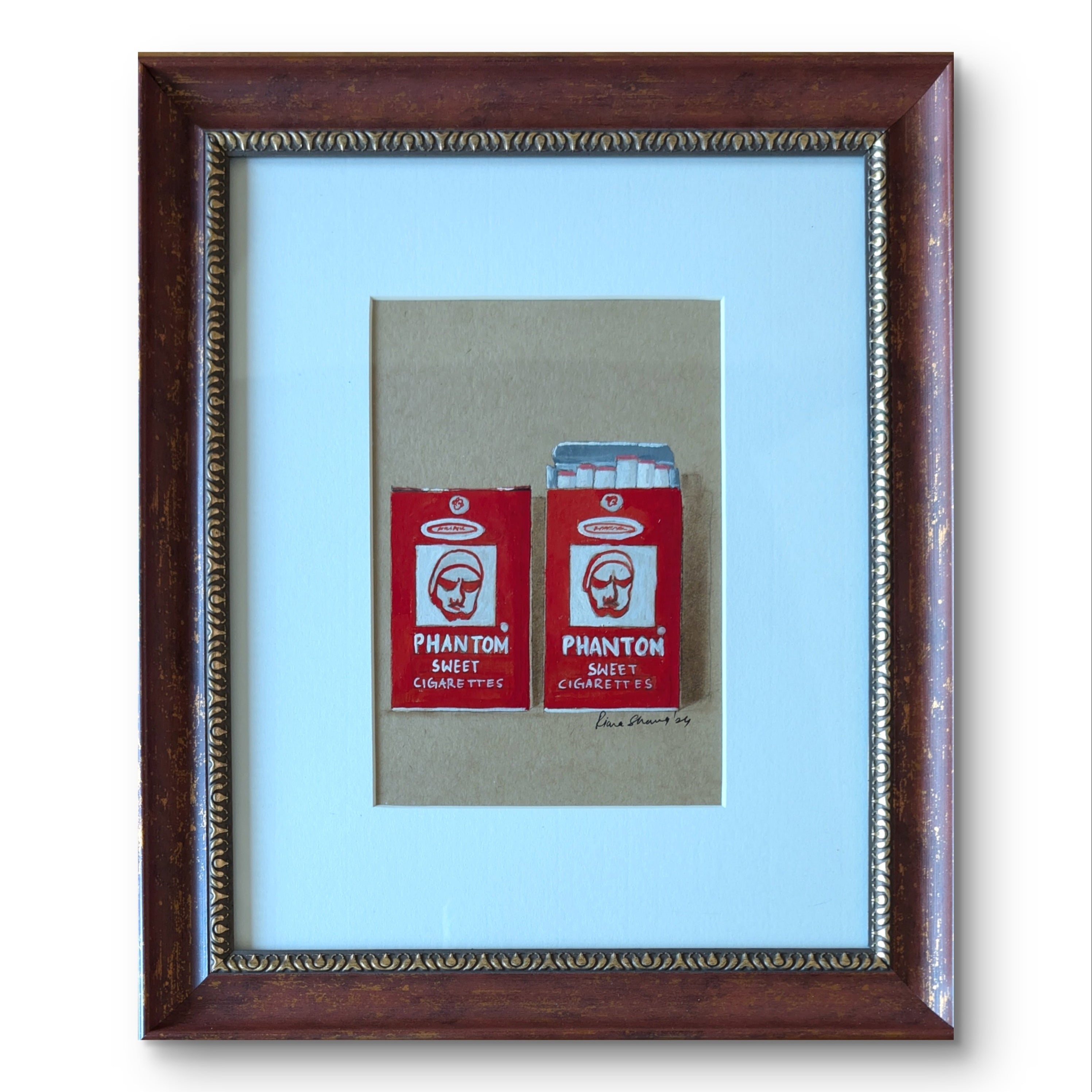 Framed artwork of two red 'Phantom' cigarette packs on a light blue background.