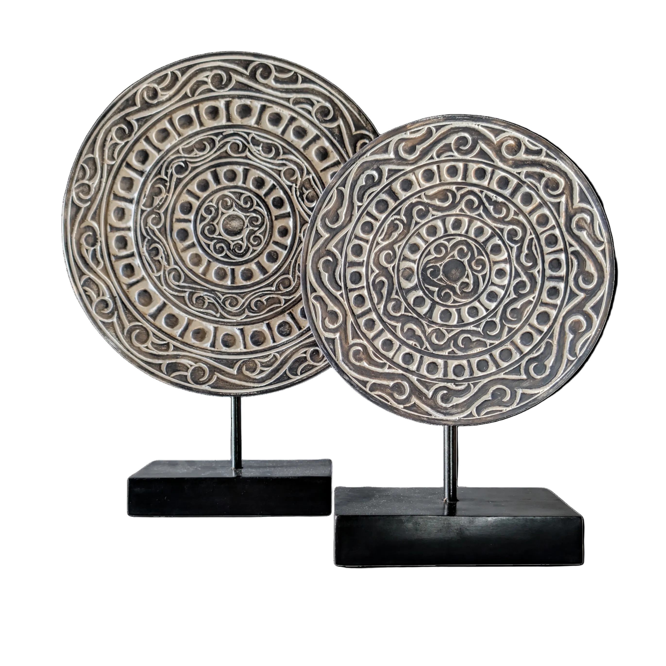 Two decorative circular plates on stands against a white background