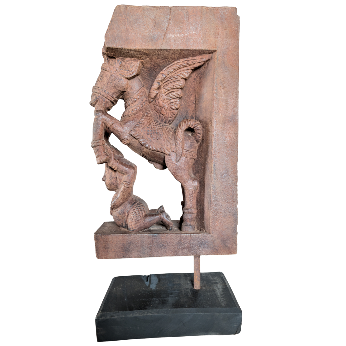 Wooden sculpture of a winged creature on a white background
