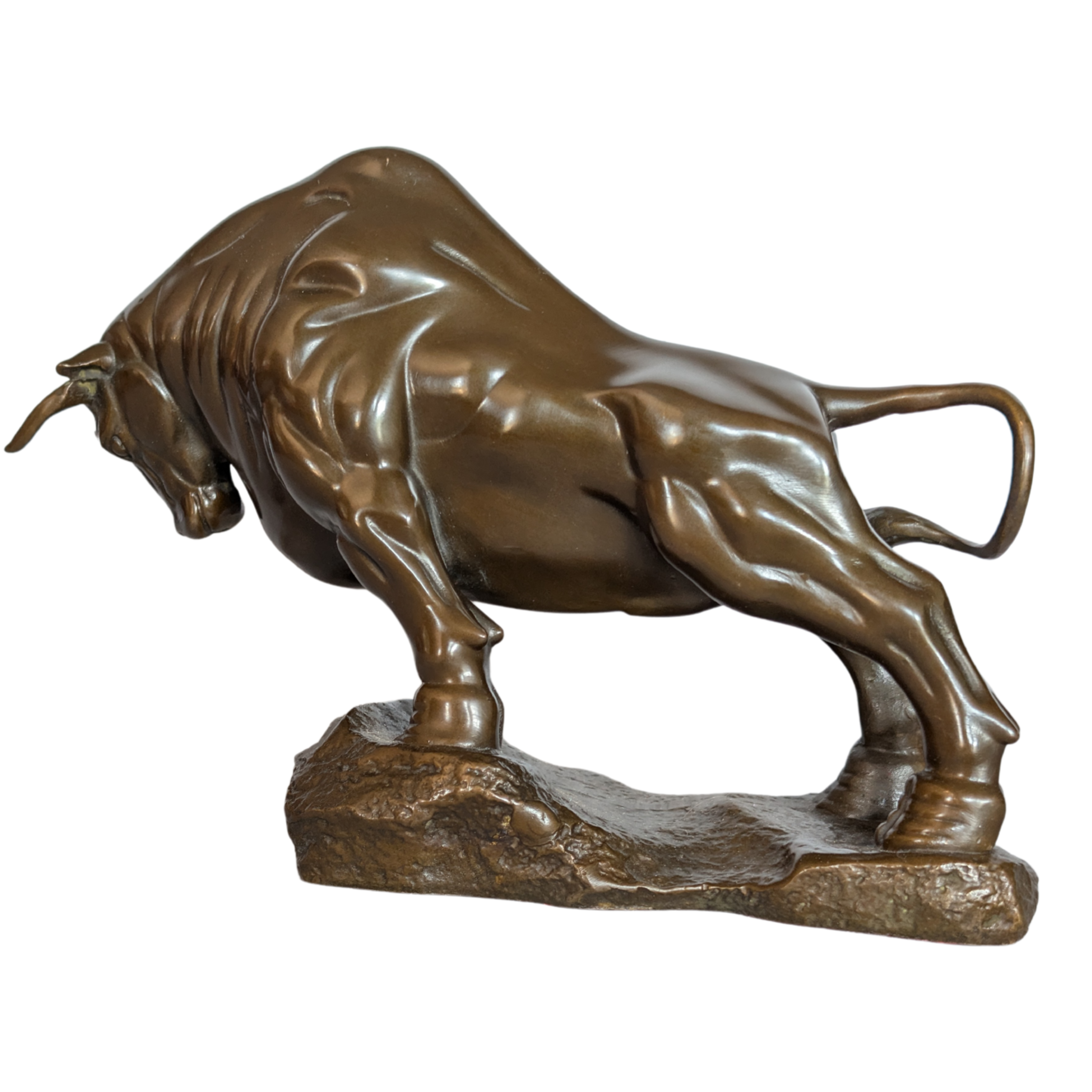 Bronze statue of a charging bull on a white background