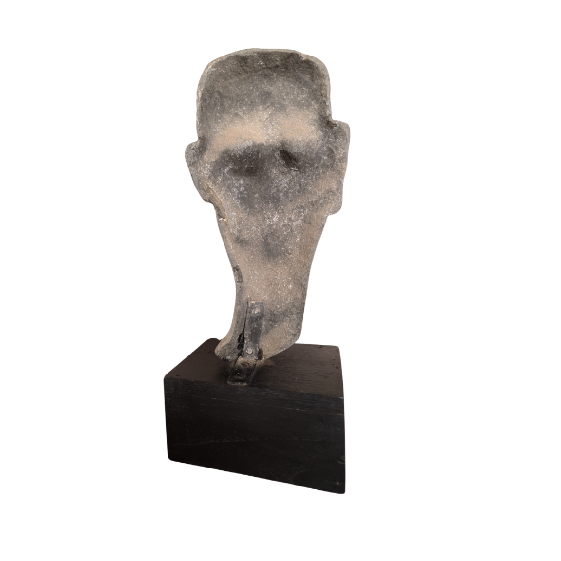 Stone sculpture of a head on a black stand against a white background